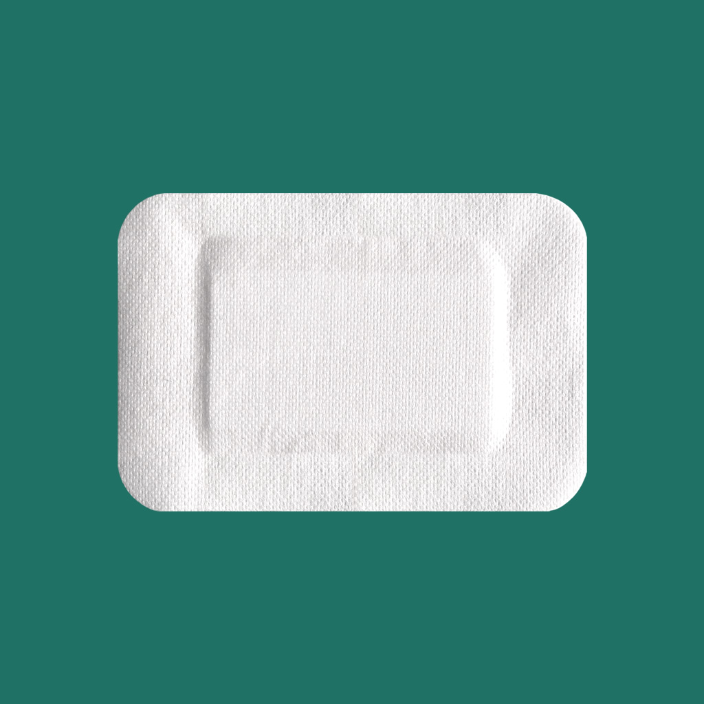Adhesive non-woven wound dressing 
